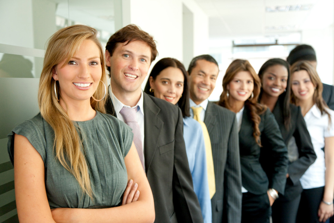 A group of people in business attire standing next to each other.